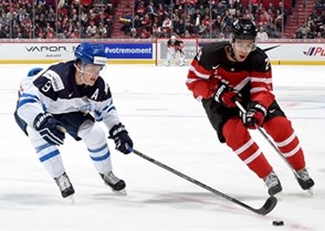MONTREAL, CANADA - DECEMBER 29: Canada's Darnell Nurse #25 stickhandles the puck away from Finland's Julius Honka #9 during preliminary round action at the 2015 IIHF World Junior Championship. (Photo by Richard Wolowicz/HHOF-IIHF Images)

