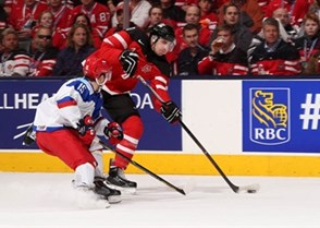 TORONTO, CANADA - JANUARY 5: Canada's Nick Paul #20 lets a shot go while Russia's Anatoli Golyshev #15 defends during gold medal game action at the 2015 IIHF World Junior Championship. (Photo by Andre Ringuette/HHOF-IIHF Images)